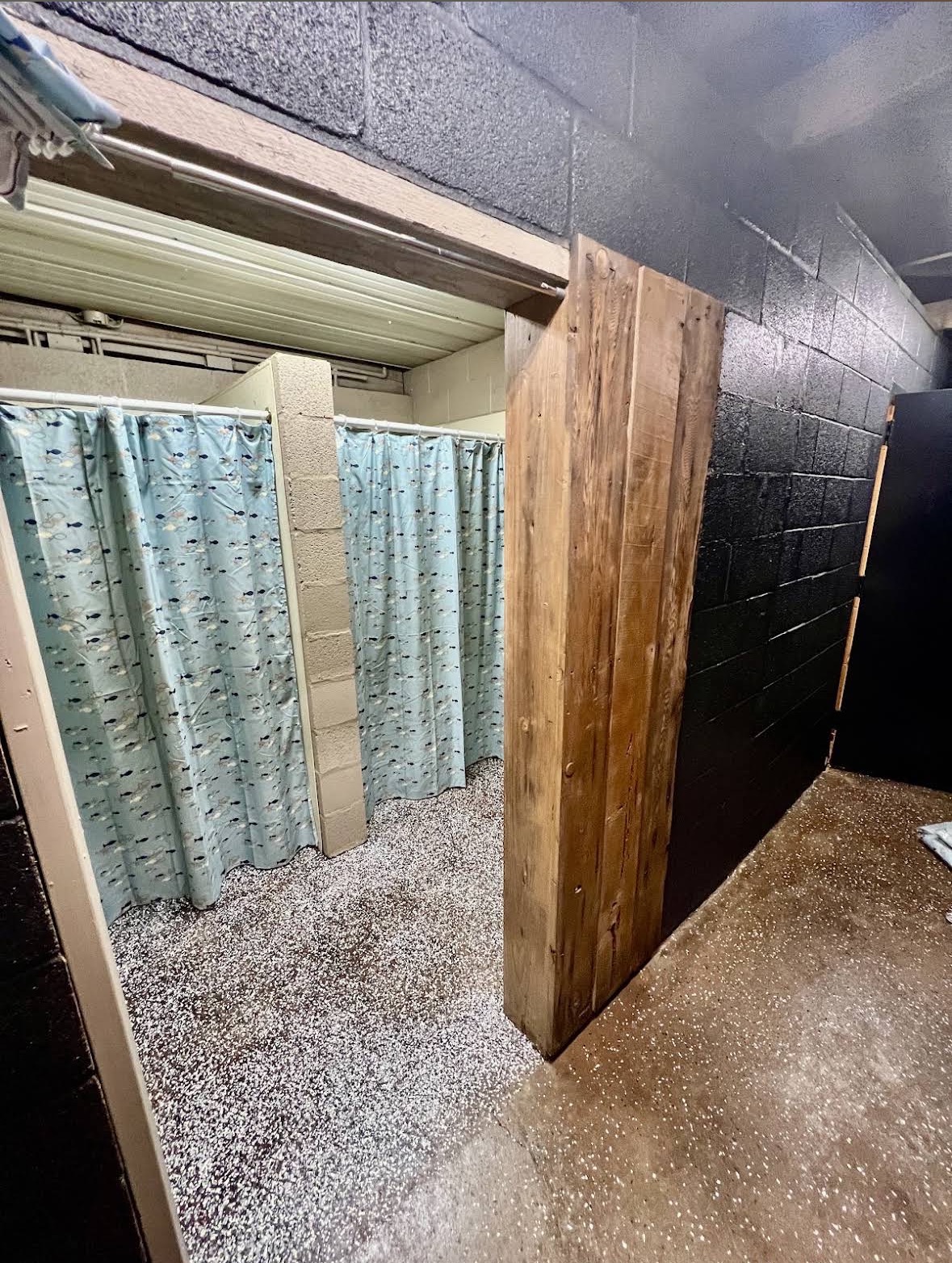 Curtained showers inside the pavilion shower house at Crazy Horse