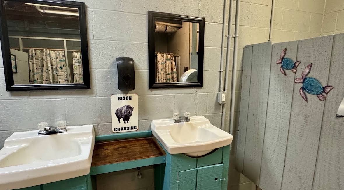 Sinks, mirrors and vintage signs inside the main shower house