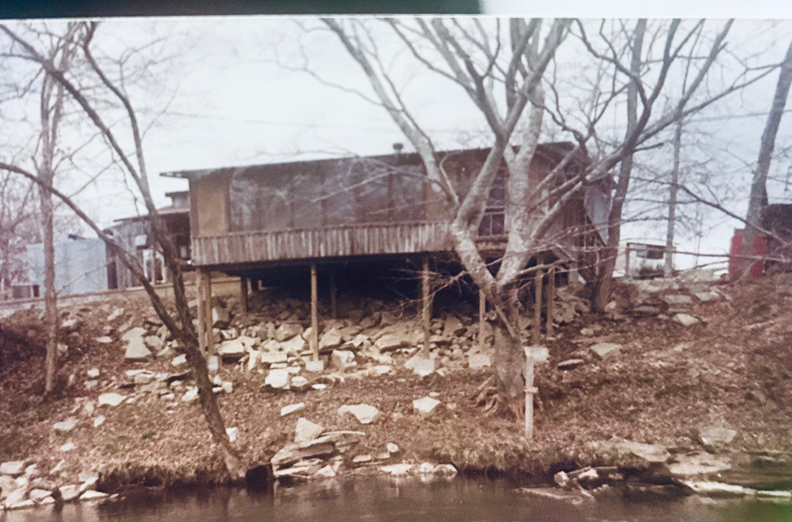 The original camp store built up on posts over the rocky riverbank