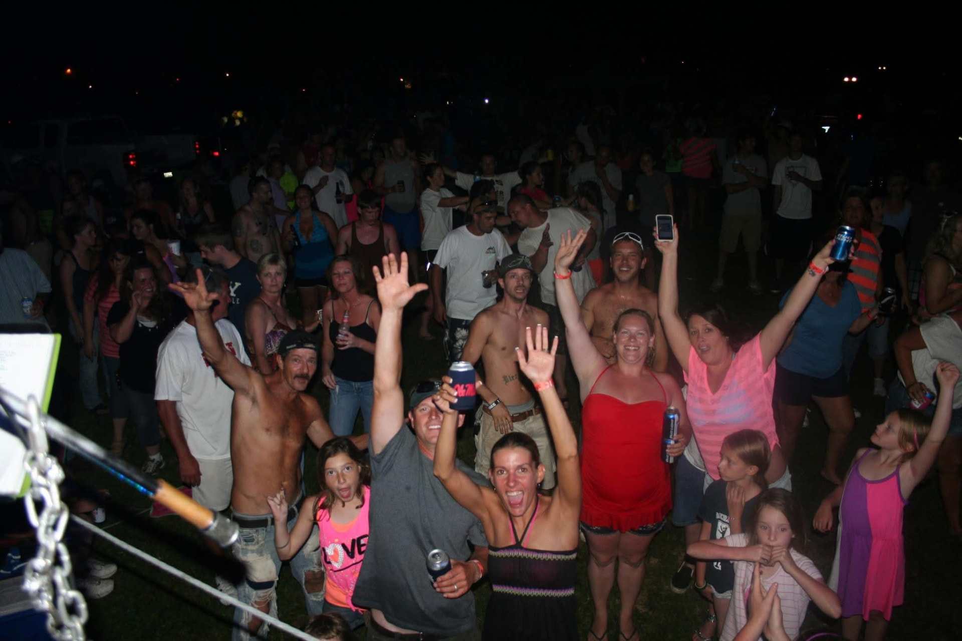 Campers cheering with hands in the air at a Crazy Horse event