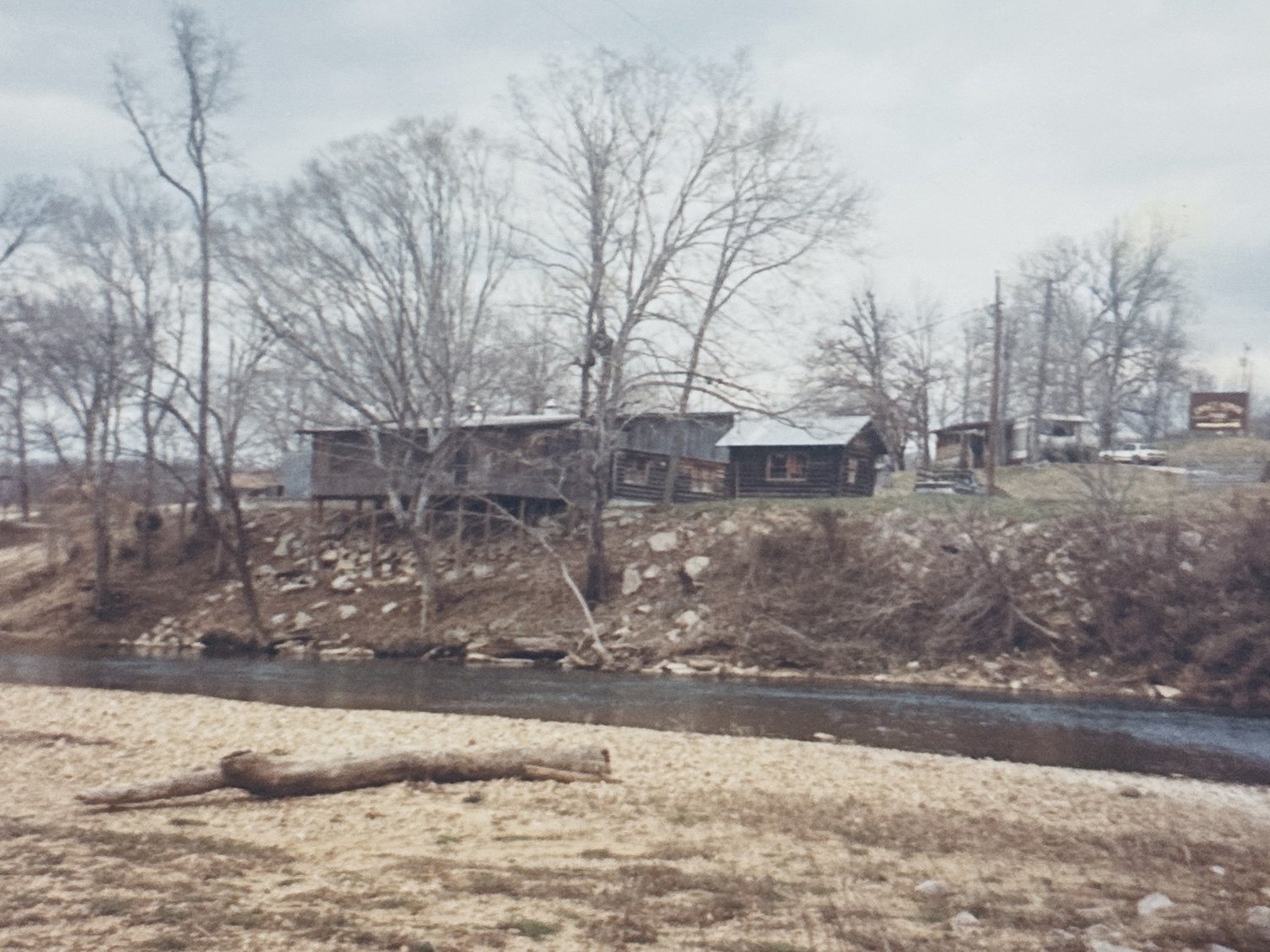 The original camp buildings sitting up on the bank above the Buffalo River in the early years