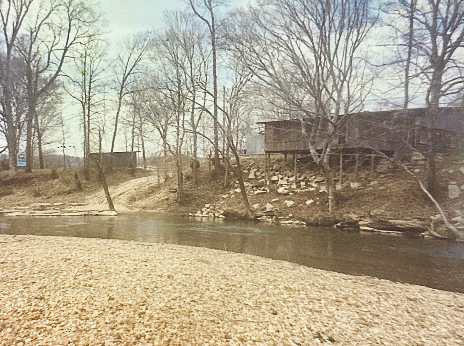 Looking across the river at the old buildings and the road down to the launch