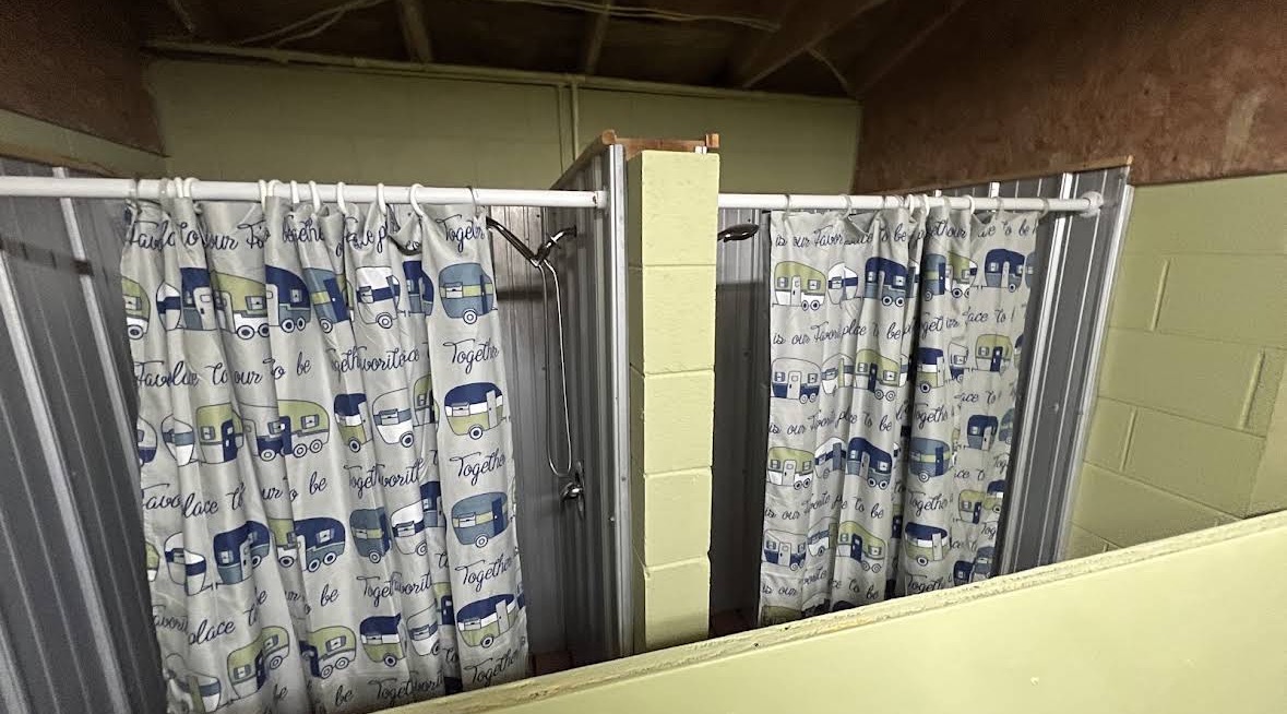 Private curtained showers inside the North Campground shower house at Crazy Horse