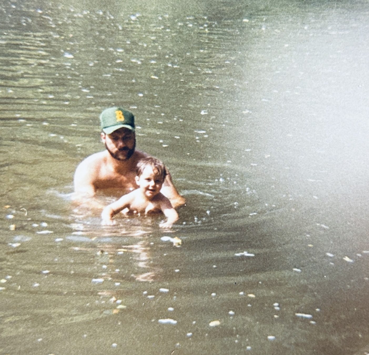 Dad holding a toddler while swimming in the Buffalo River
