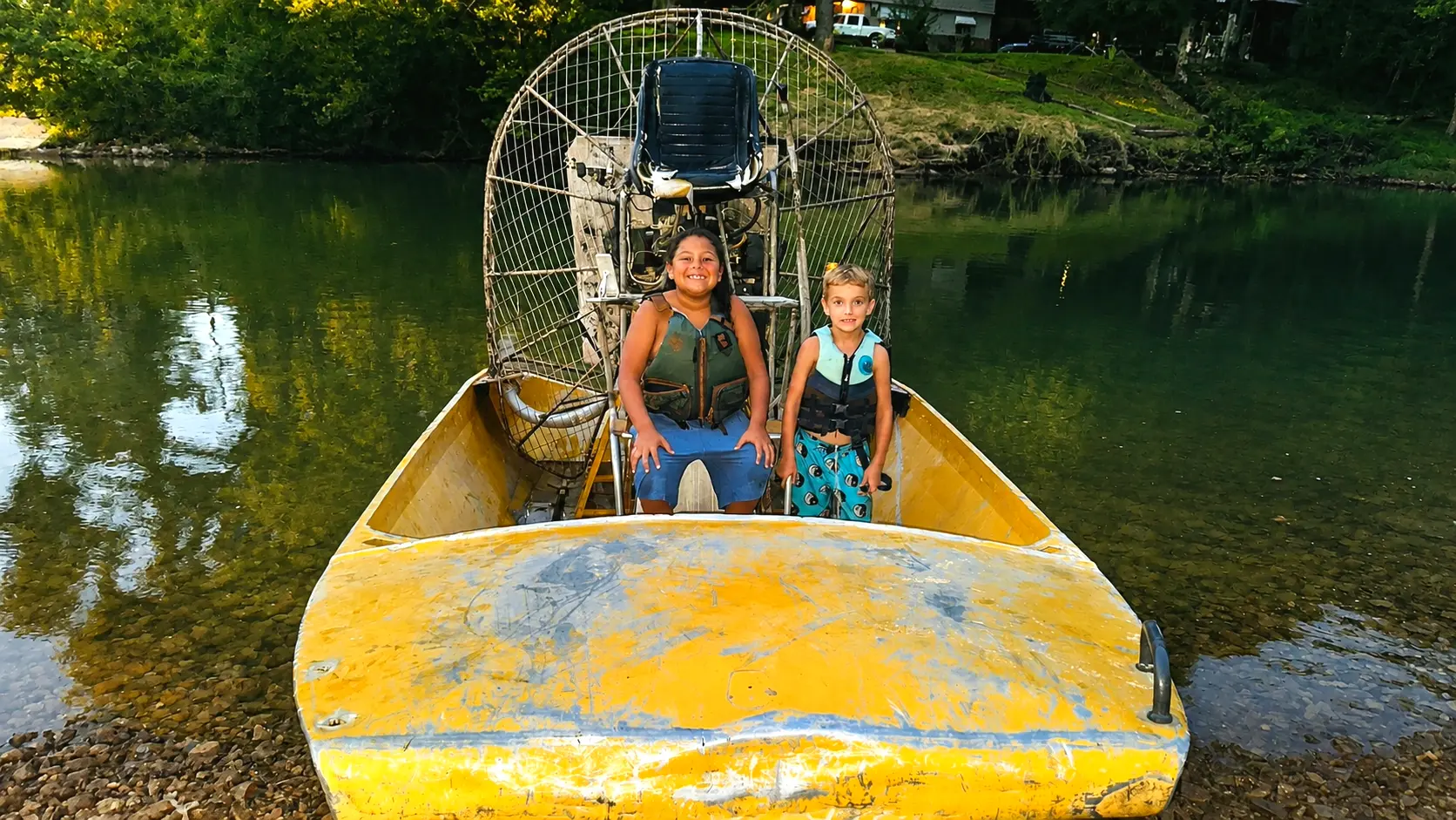 Two children sitting in the Crazy Horse river rescue airboat
