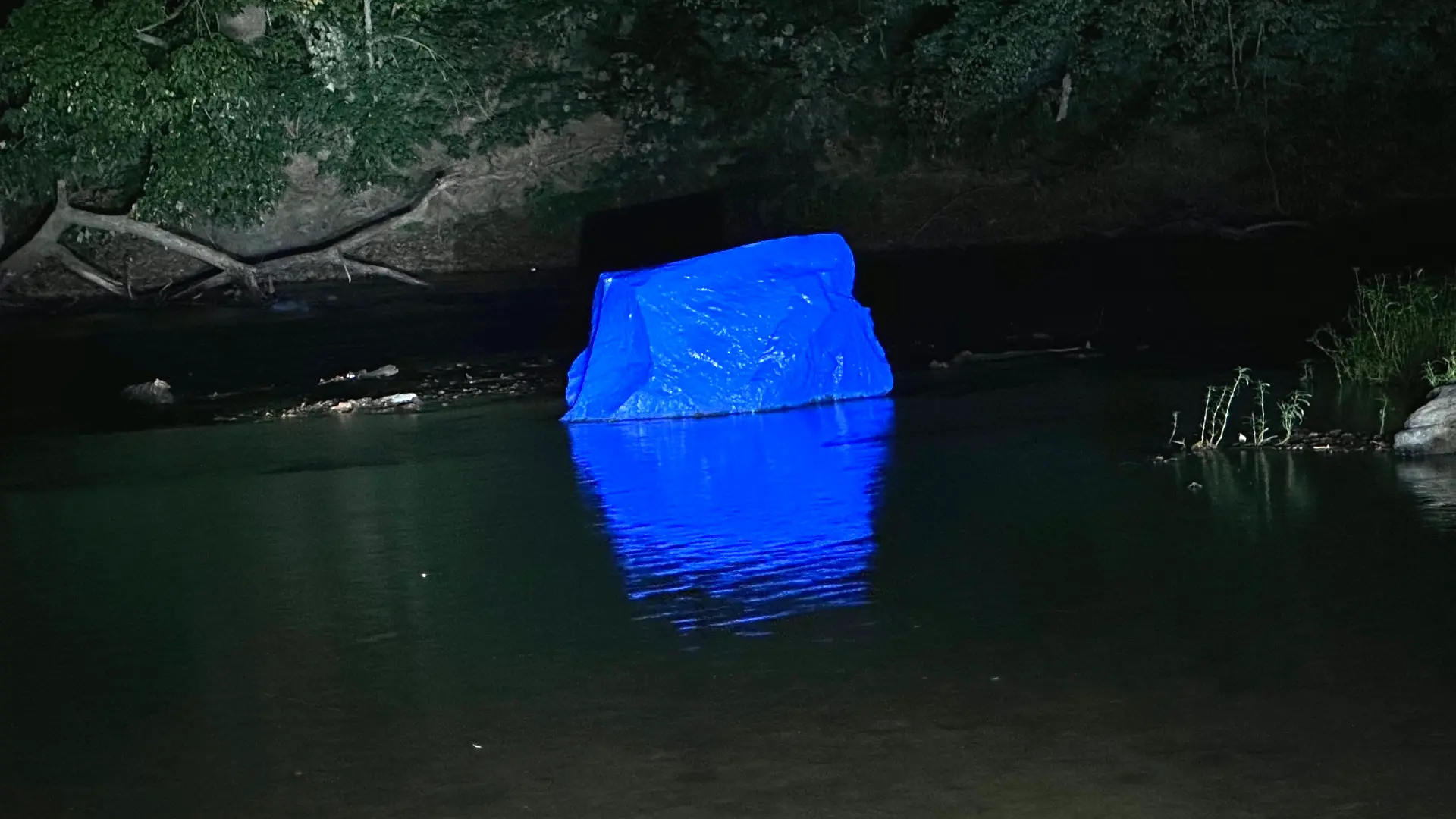 The famous blue rock glowing on the Buffalo River at night