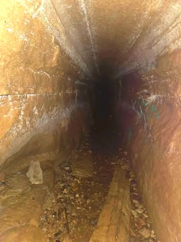 Narrow stone tunnel inside a Buffalo River bluff cave