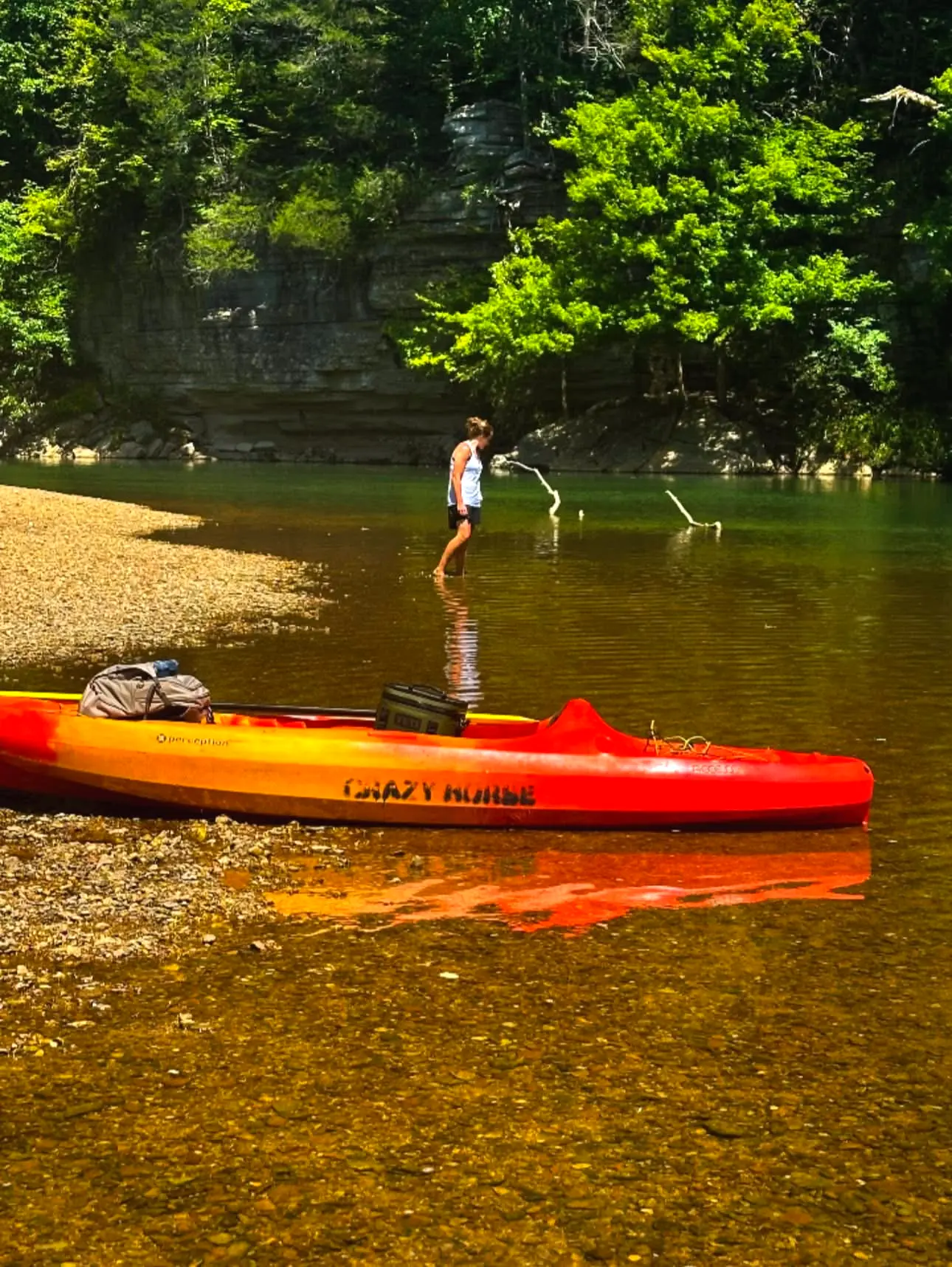 A Crazy Horse kayak beached below the bluffs