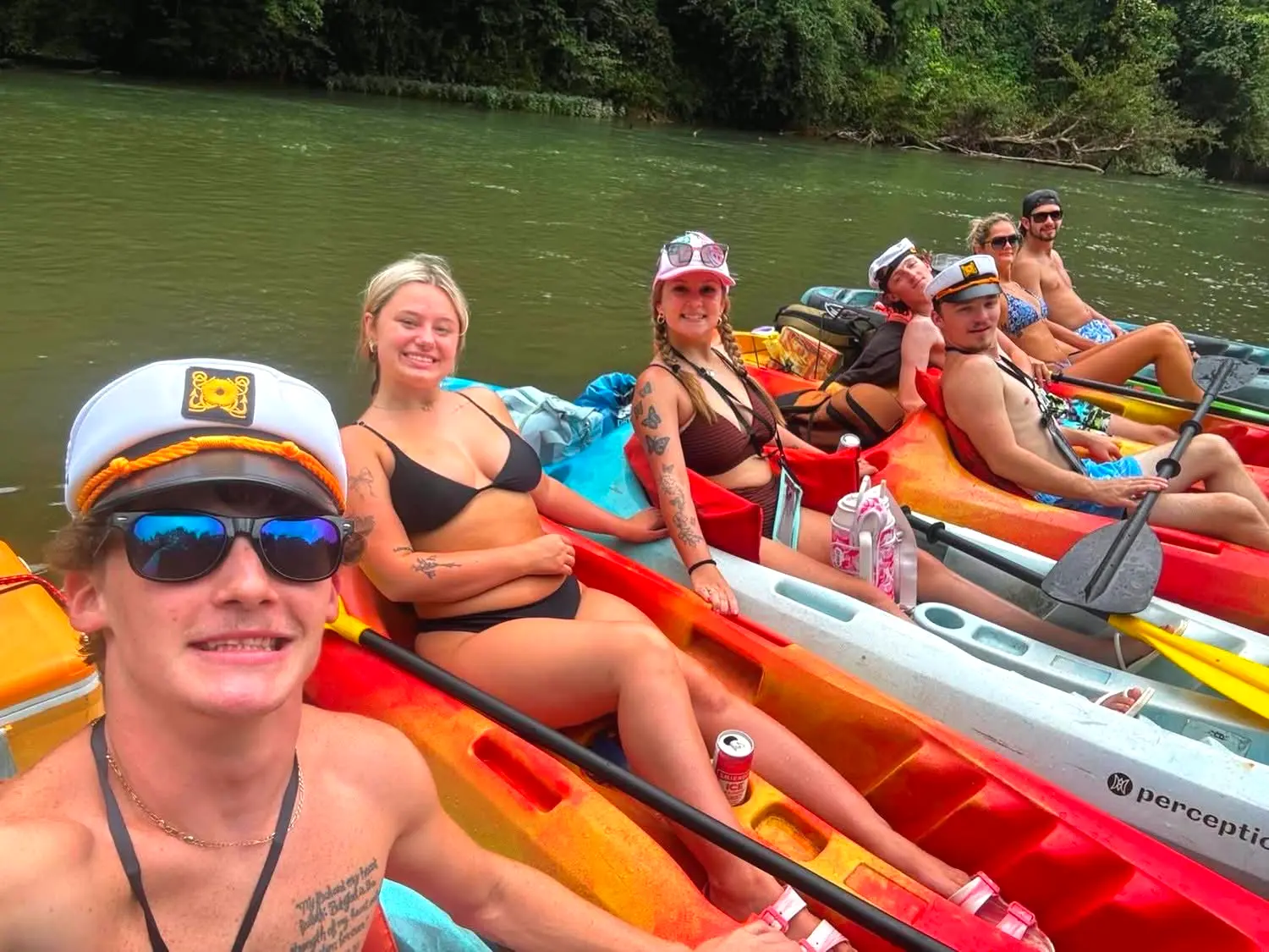 A crew of friends rafted up in kayaks on the float