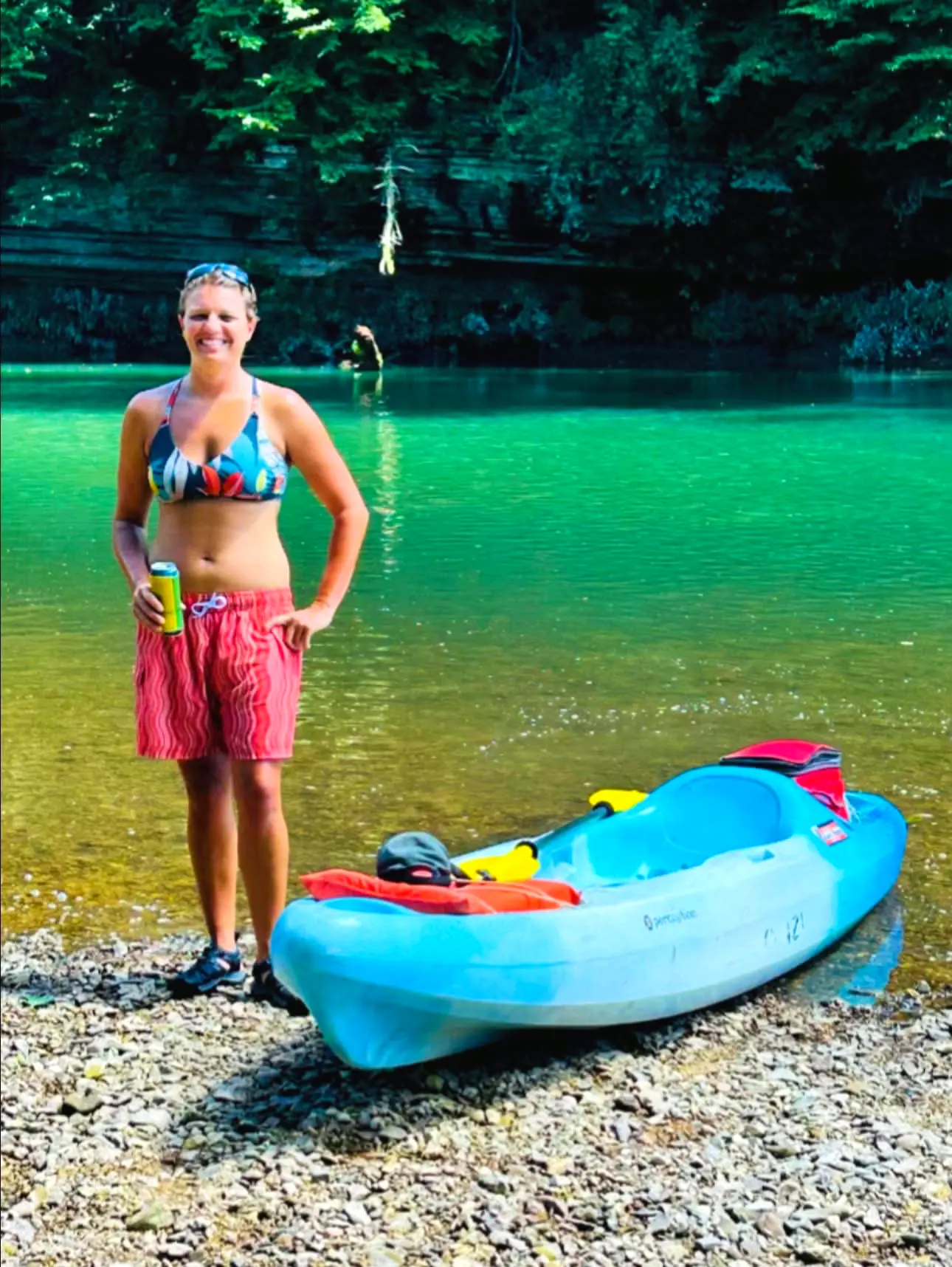 Kayak pulled onto a gravel bar in emerald water