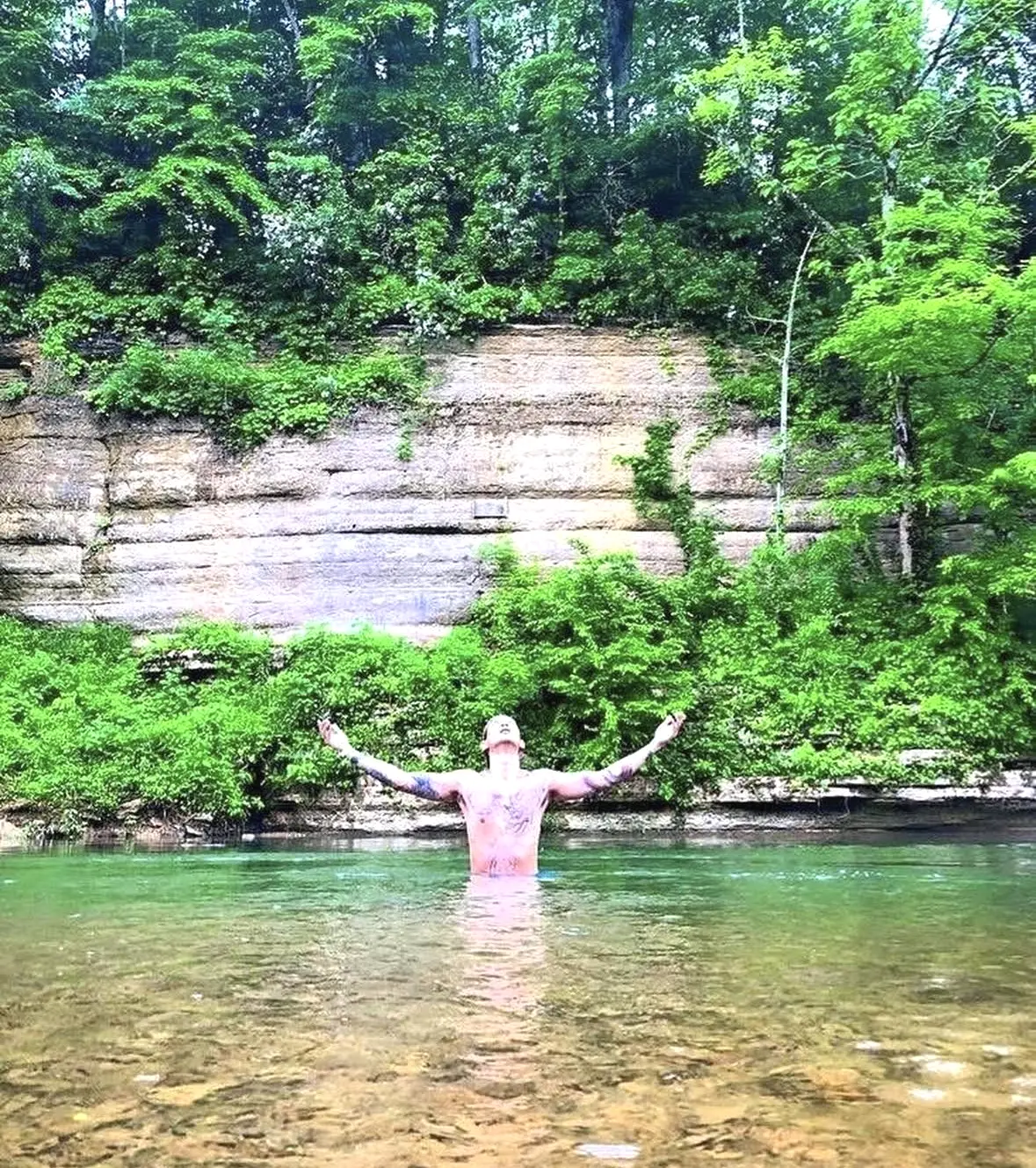 Standing in the clear water beneath the bluffs